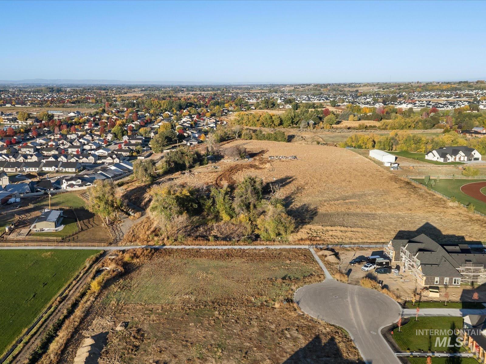 Aerial overview of property's location featuring nearby suburban area