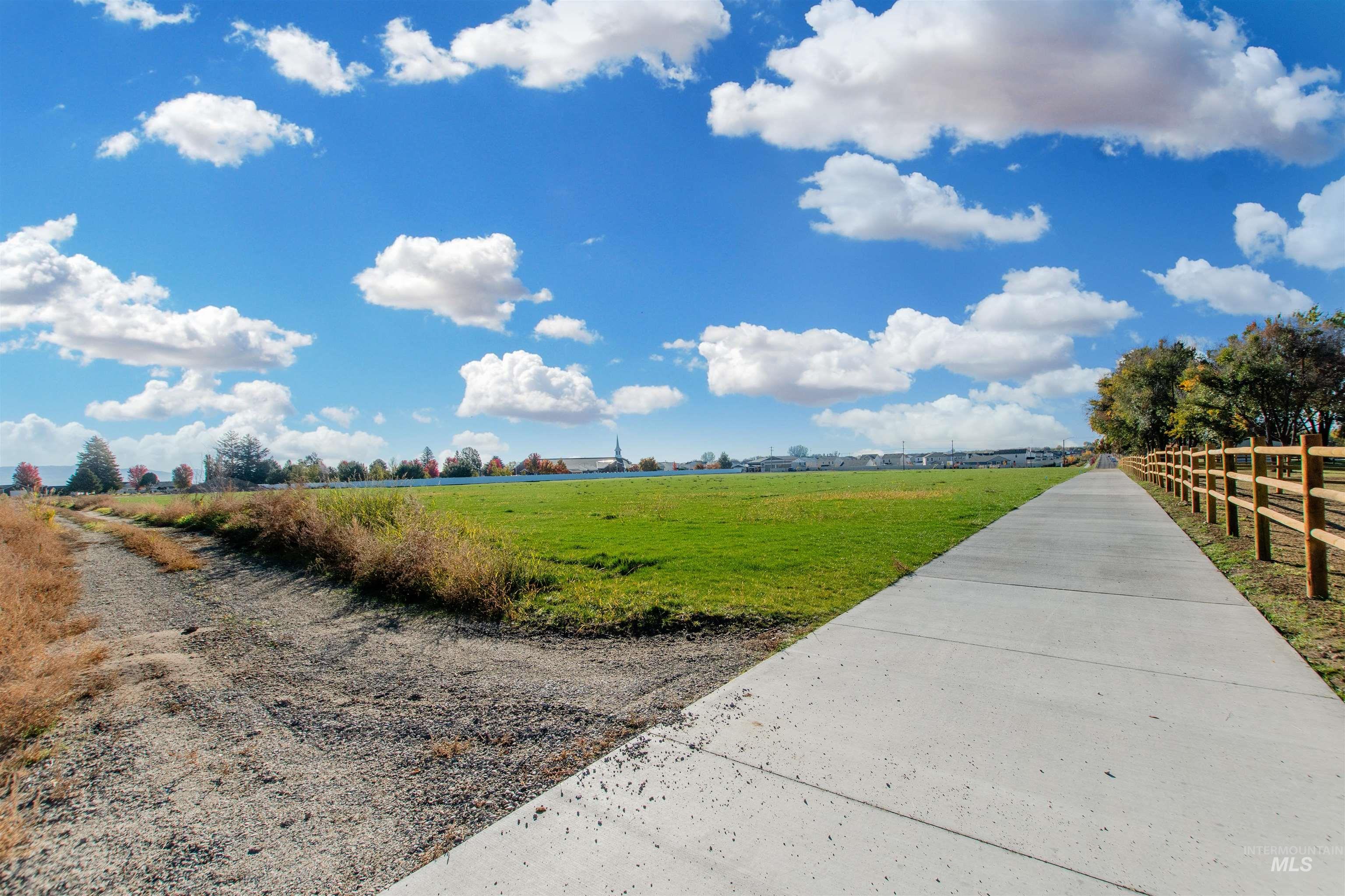 View of home's community featuring a view of countryside and a yard
