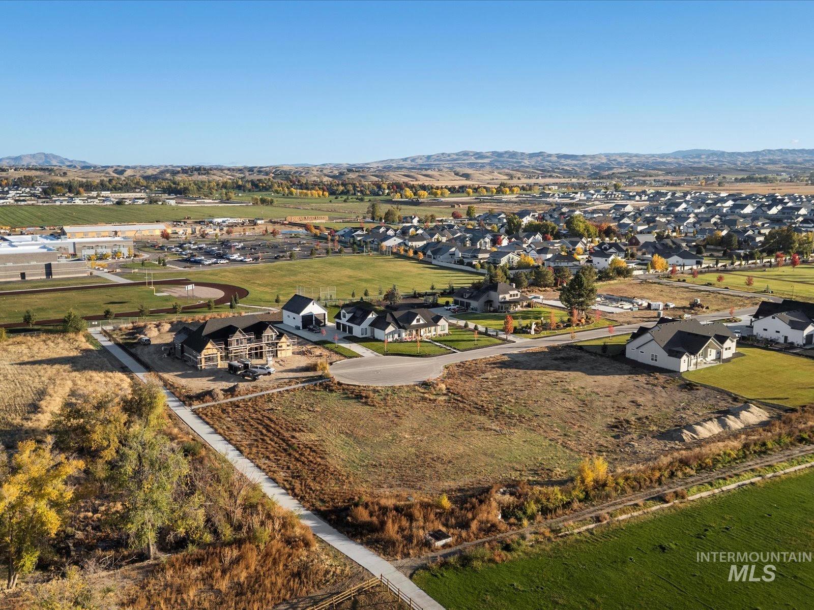 Aerial perspective of suburban area featuring a mountainous background