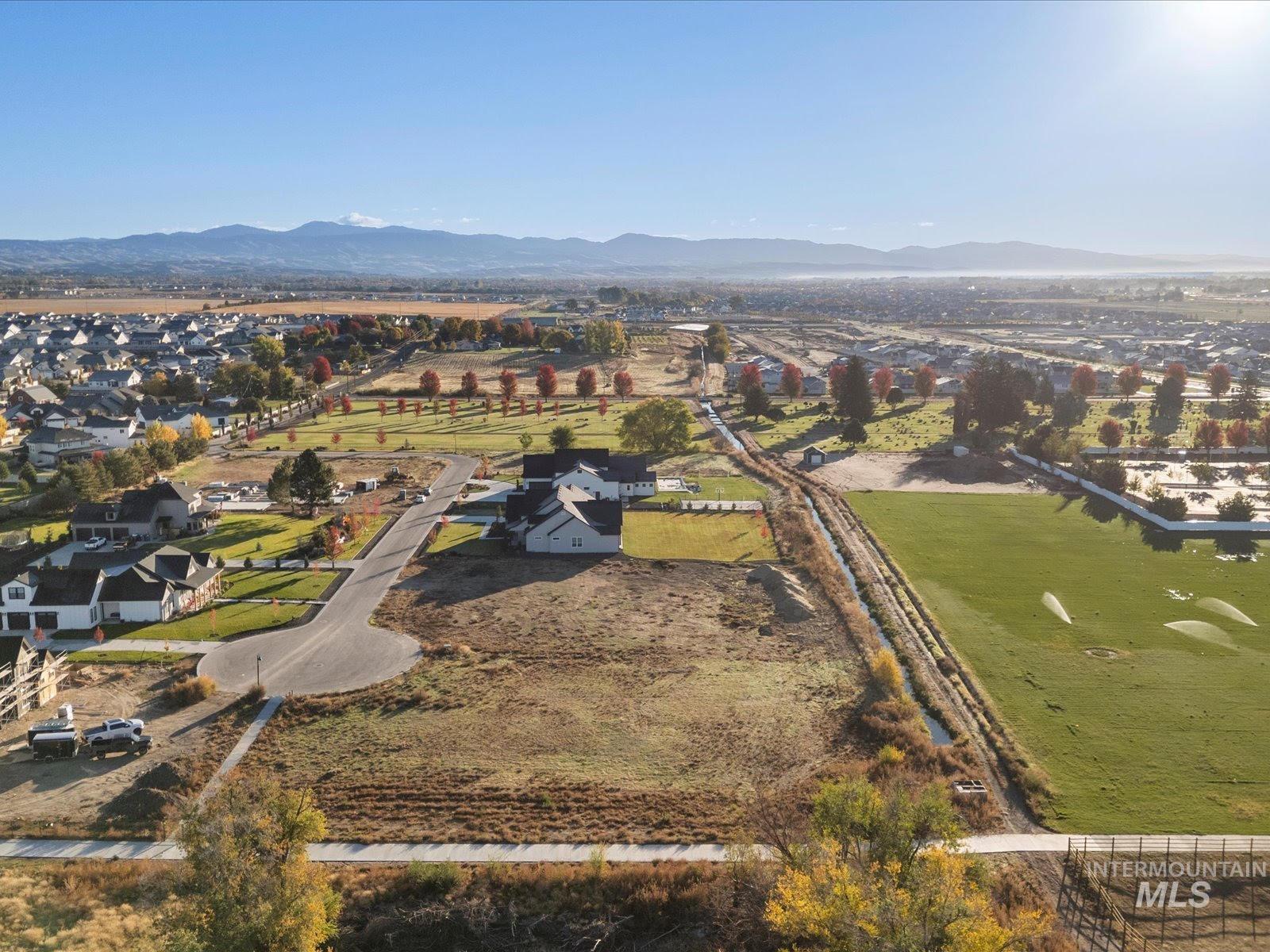 View of property location featuring a mountain backdrop and nearby suburban area