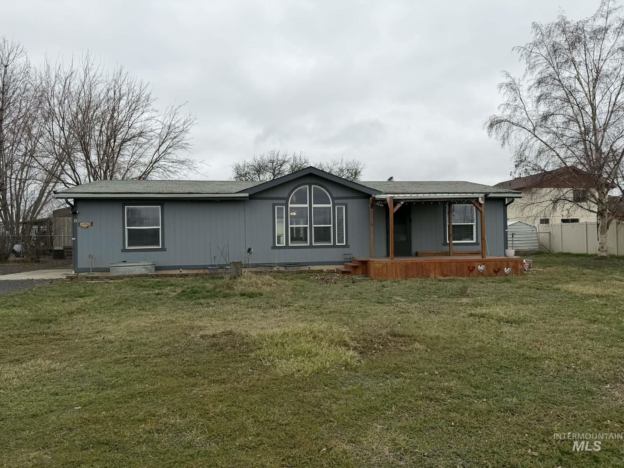 View of front facade with roof with shingles and a deck