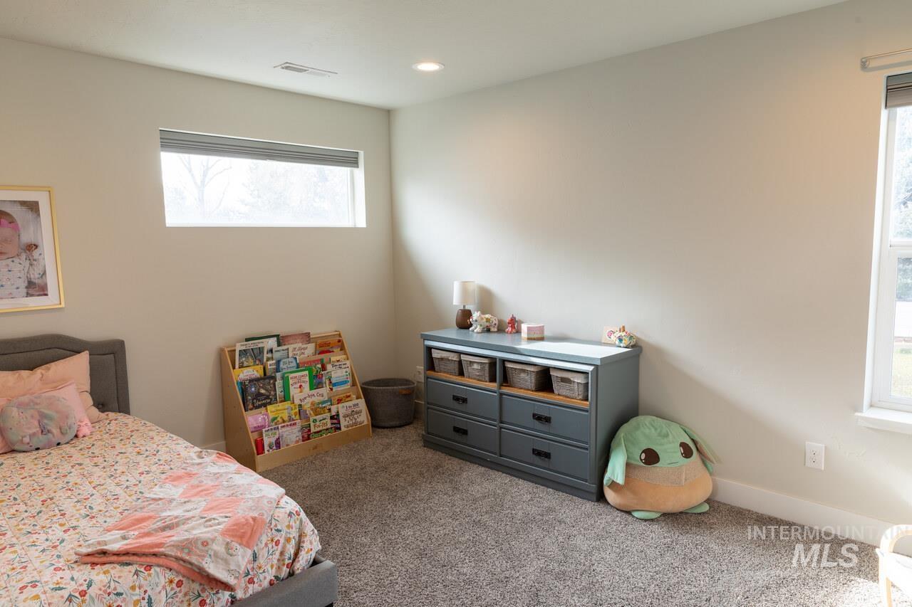 Carpeted bedroom featuring baseboards and recessed lighting