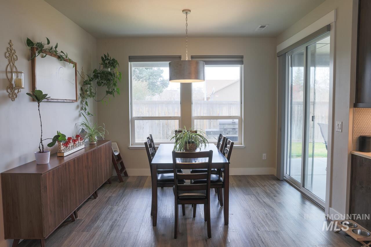 Dining room with dark wood-style floors