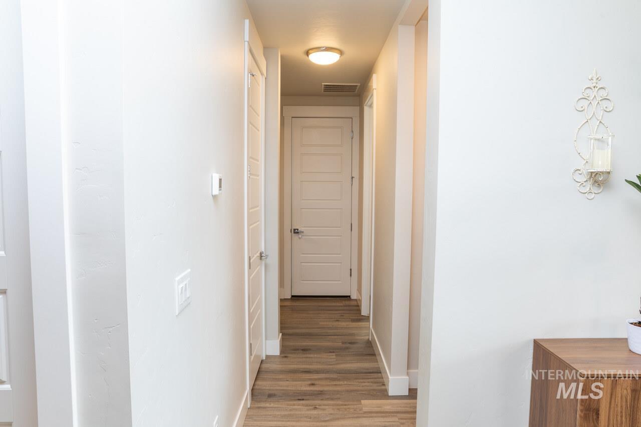 Corridor featuring baseboards and light wood-type flooring