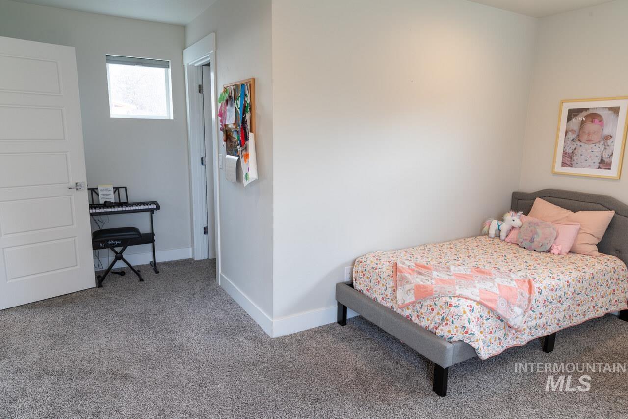 Carpeted bedroom featuring baseboards