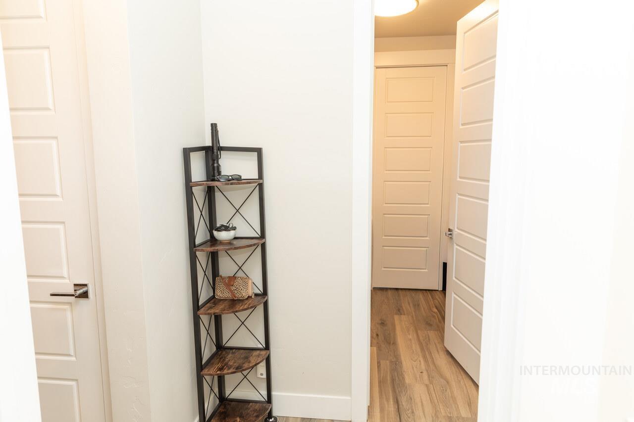 Hall with light wood-style flooring and baseboards