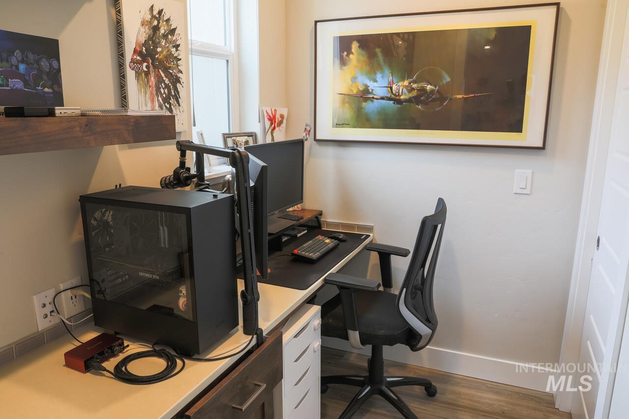 Office area with baseboards and dark wood finished floors