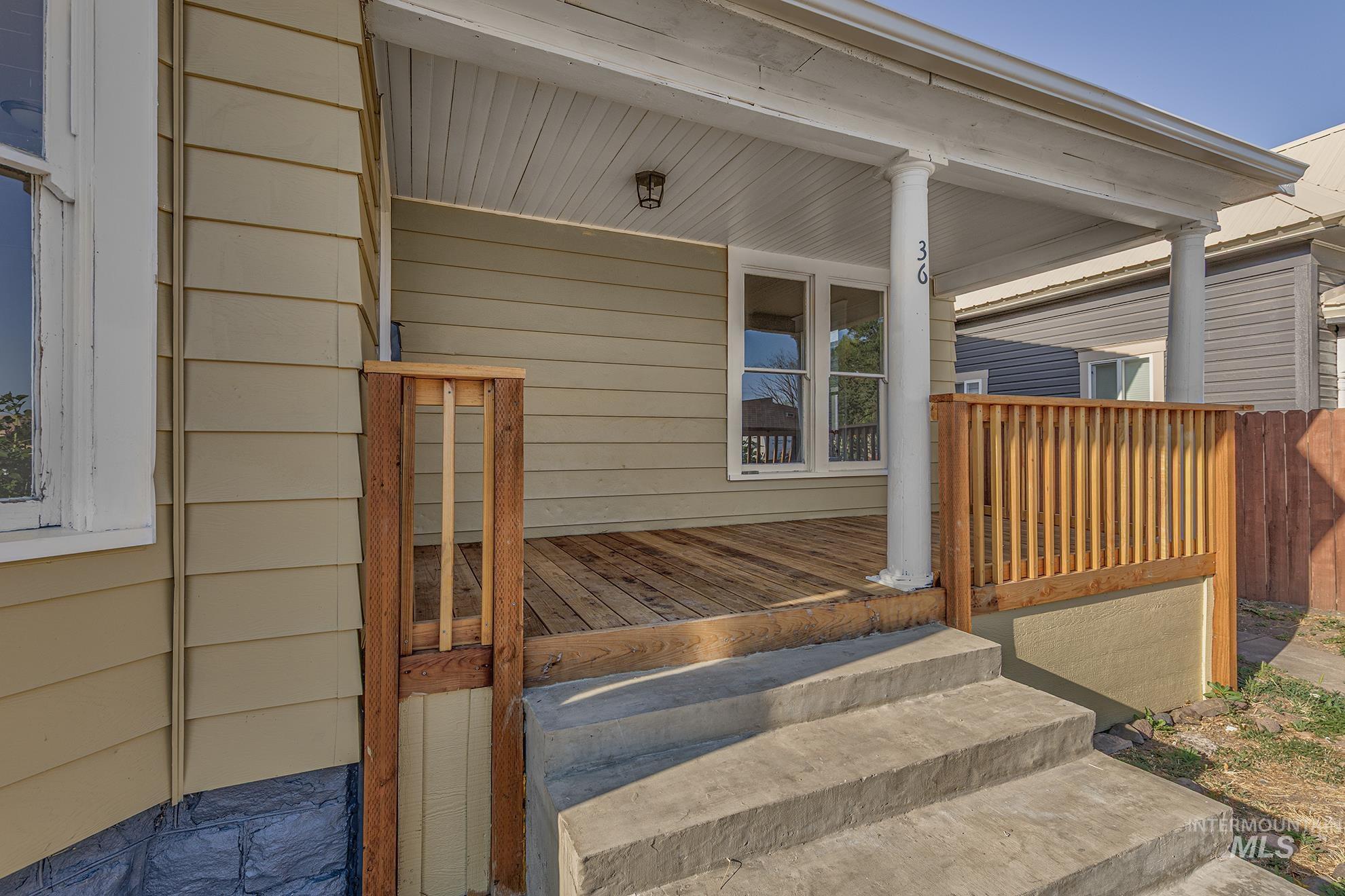Doorway to property featuring covered porch