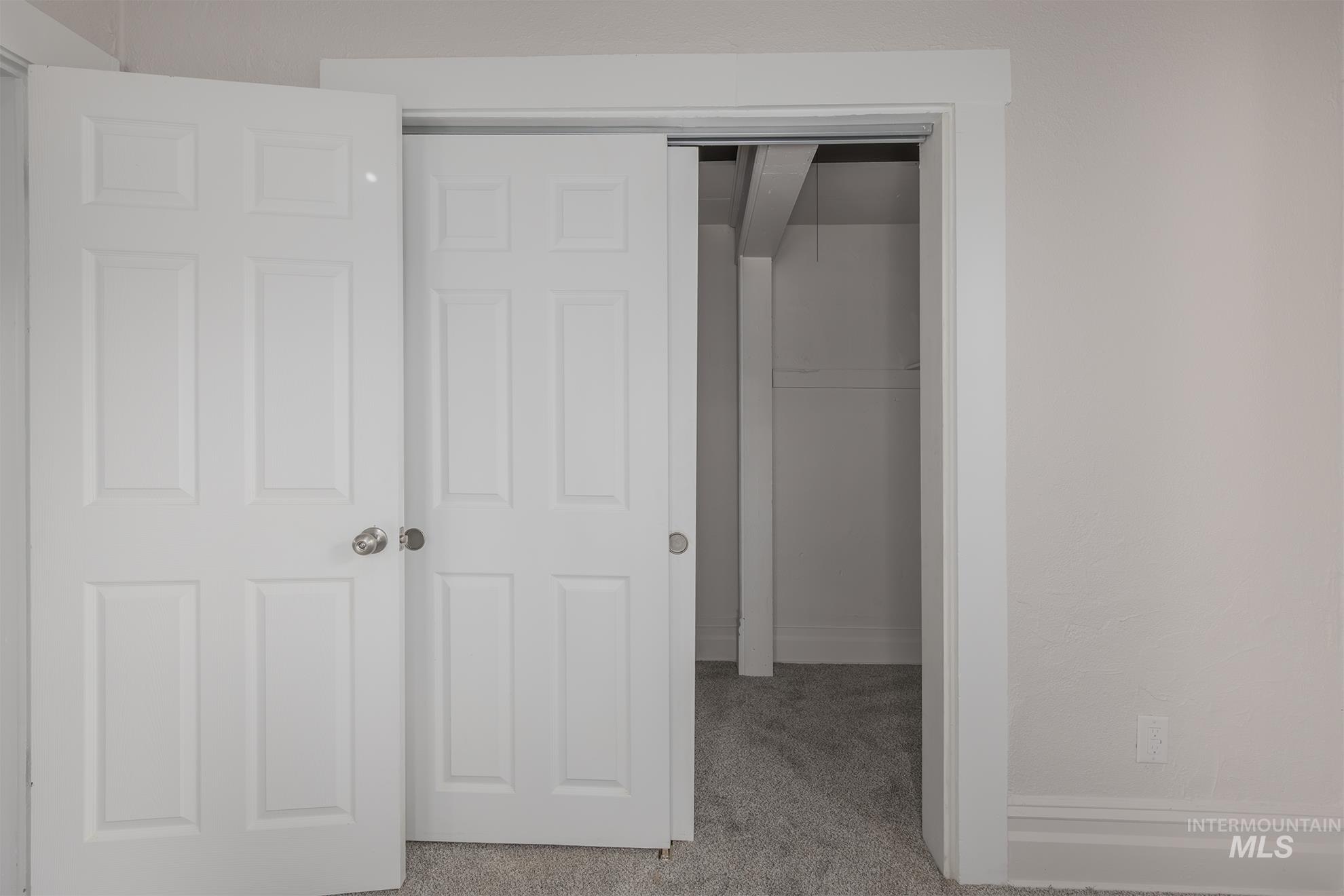 Unfurnished bedroom with carpet and a closet