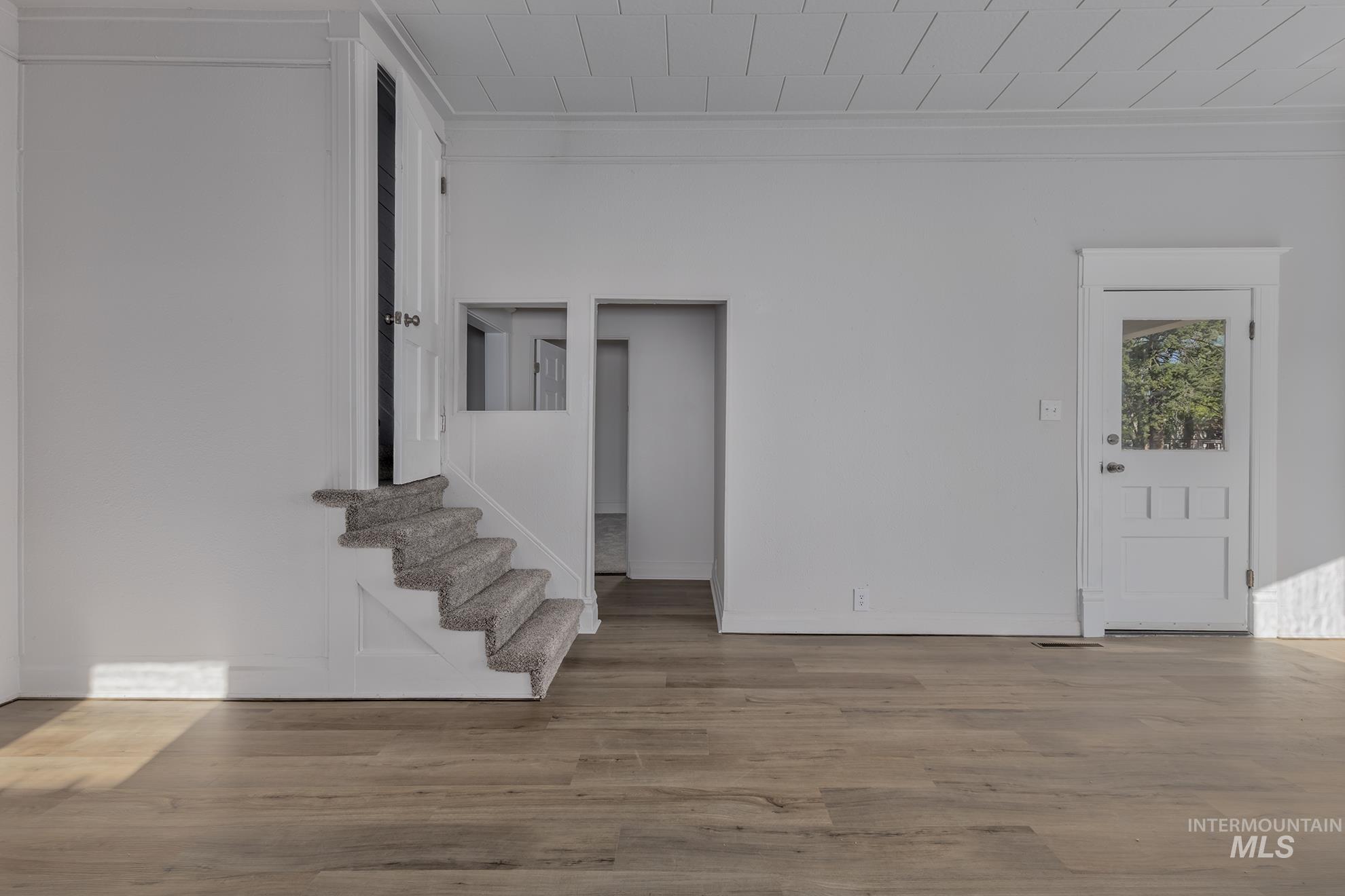 Empty room featuring wood finished floors and stairway
