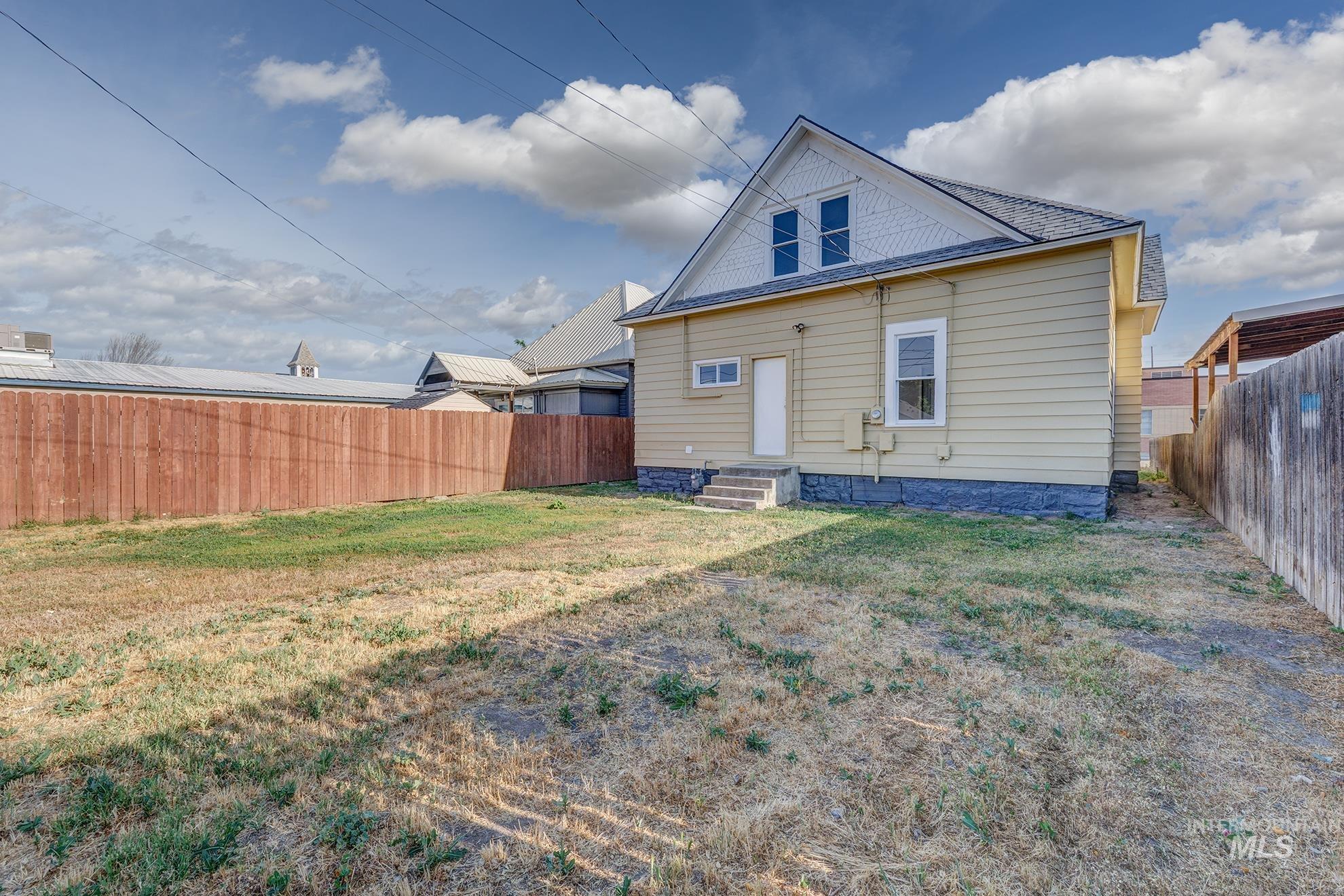 Back of property featuring a fenced backyard