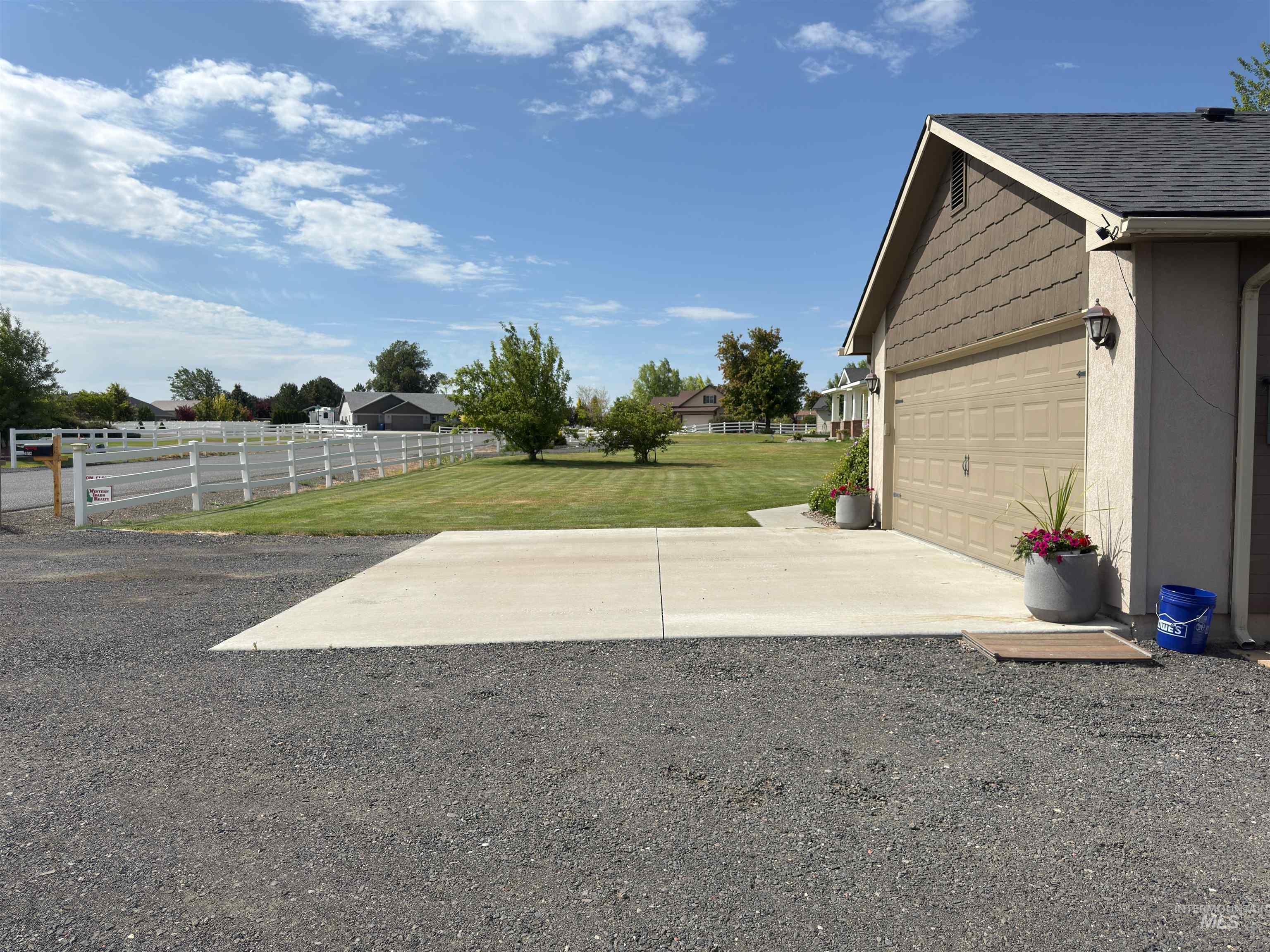 View of yard featuring concrete driveway