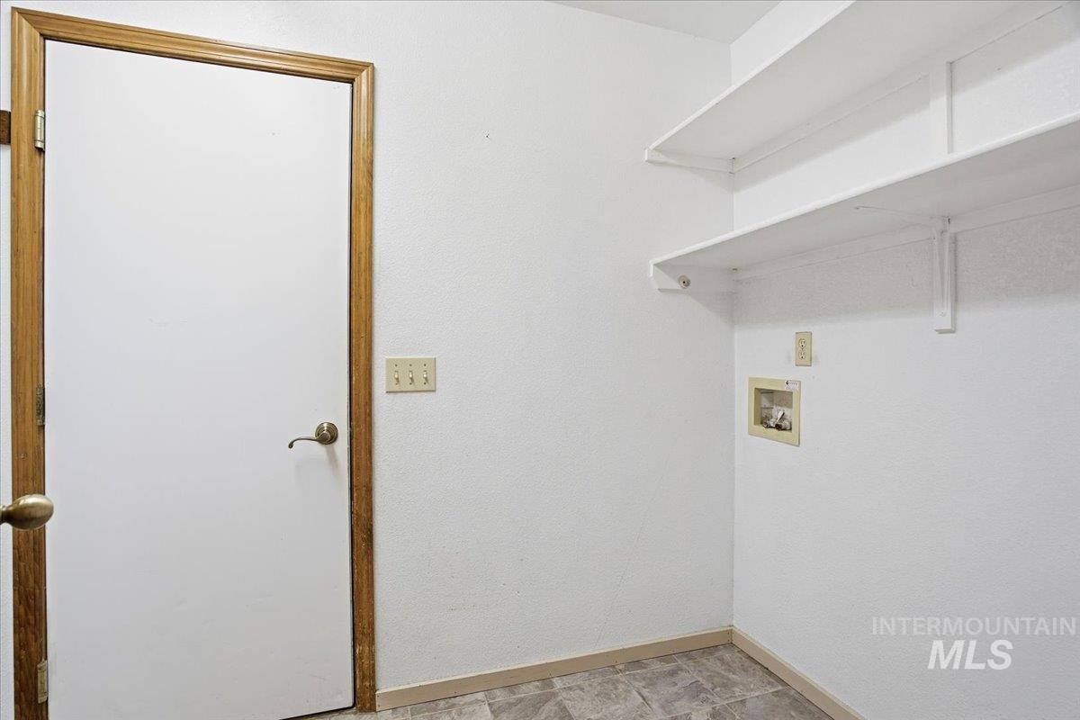 Washroom featuring baseboards and hookup for a washing machine