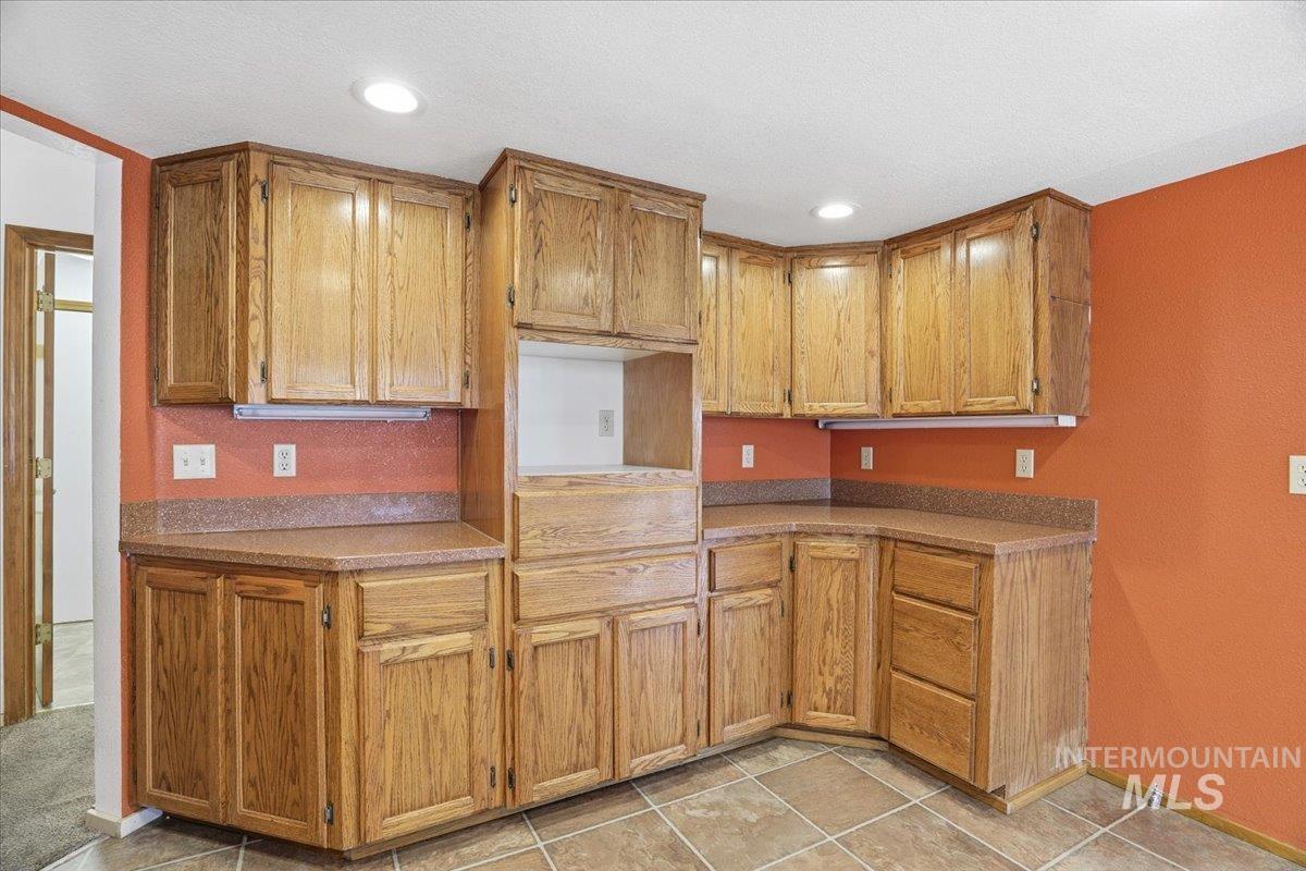 Kitchen featuring brown cabinets and recessed lighting