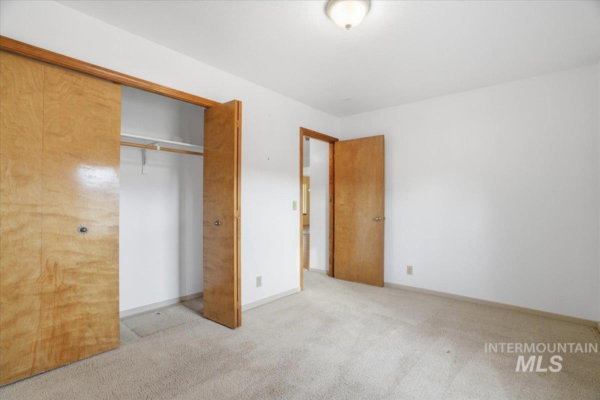 Unfurnished bedroom with carpet flooring and a closet