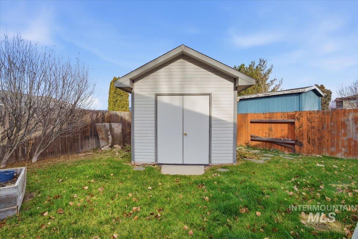 View of shed with a fenced backyard