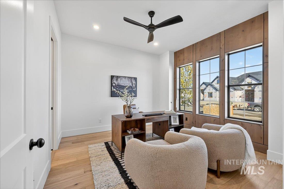 Home office featuring light wood finished floors, a ceiling fan, and recessed lighting