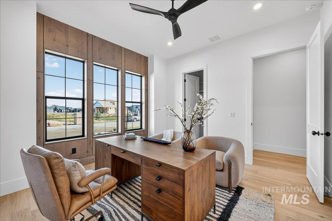 Home office featuring light wood-type flooring, ceiling fan, and recessed lighting