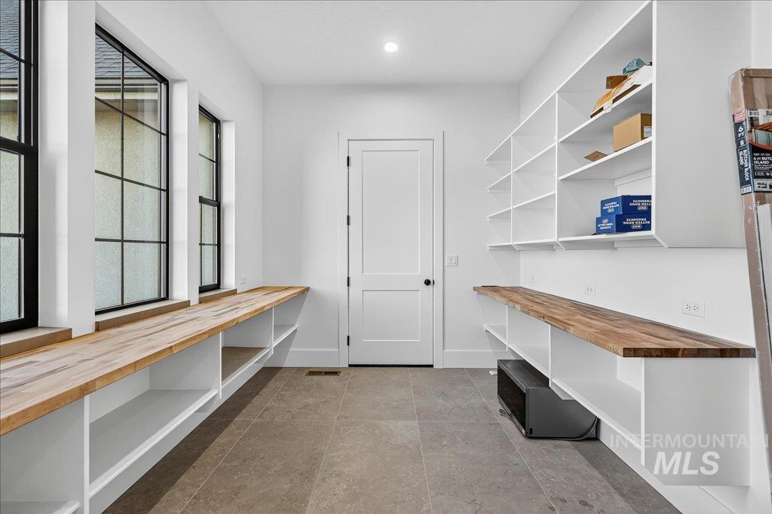 Mudroom with recessed lighting and light tile patterned floors