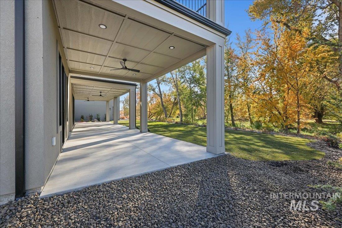 Patio / terrace with a ceiling fan, a patio, and a yard