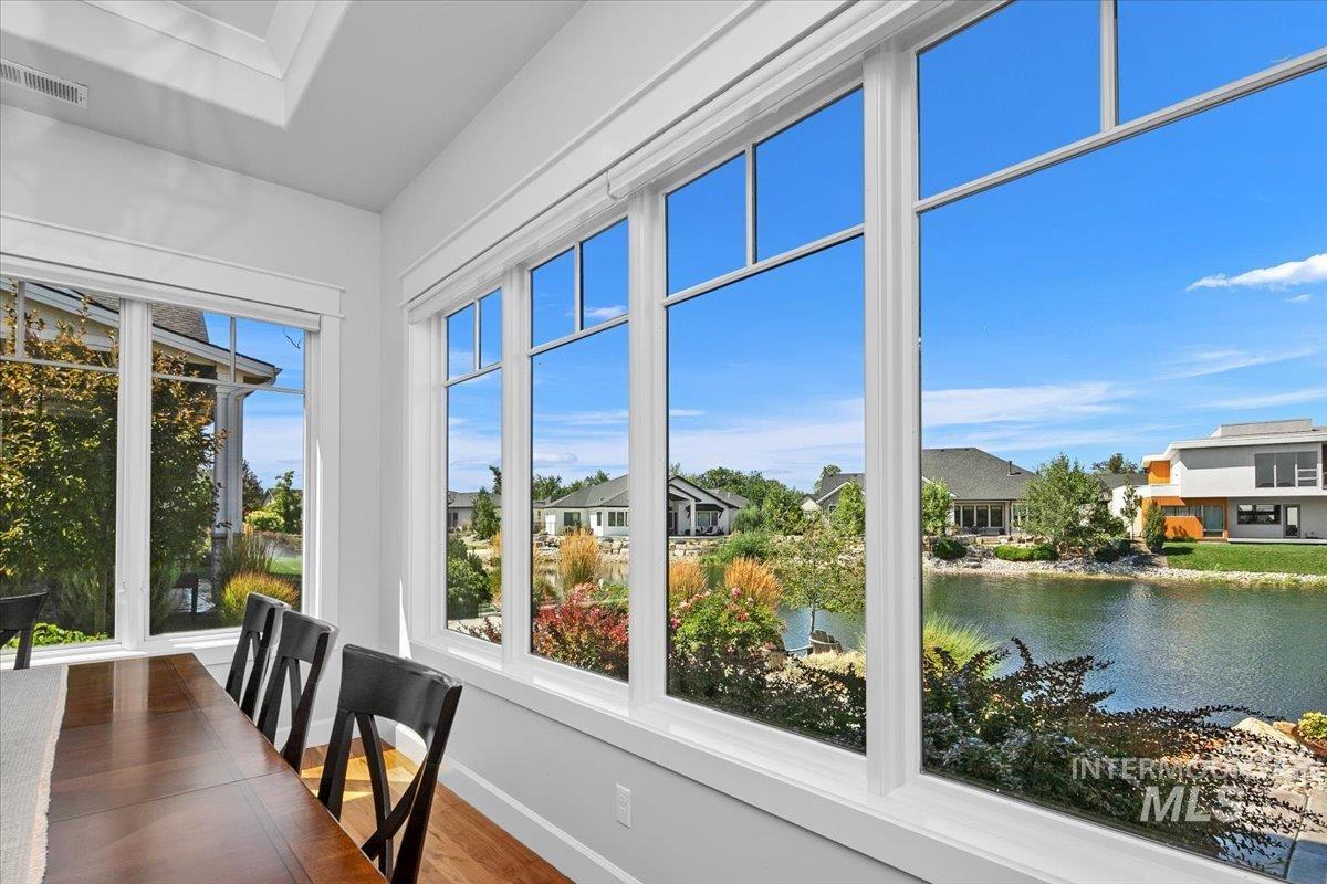 Dining room featuring wood finished floors and a water view