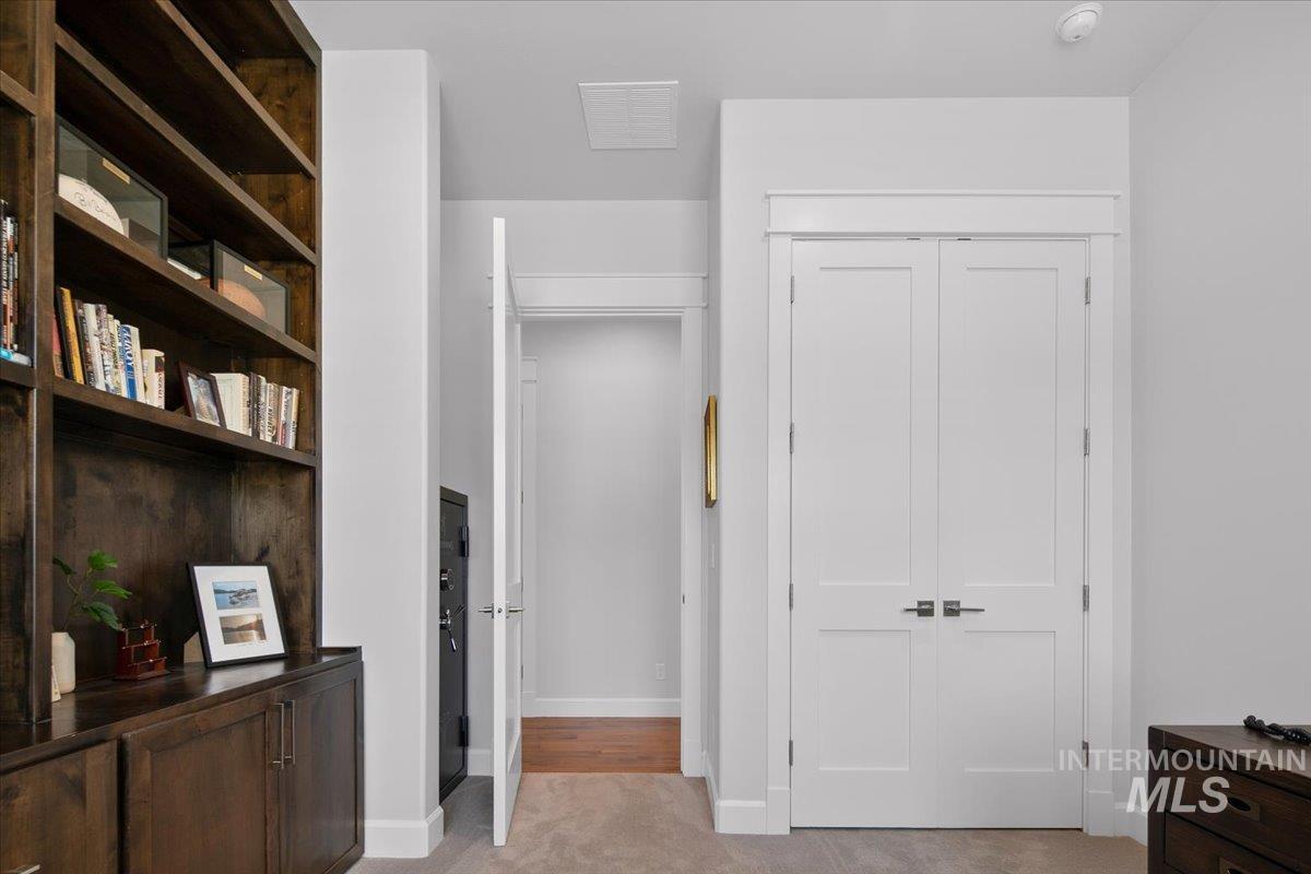 Hall with light carpet and baseboards