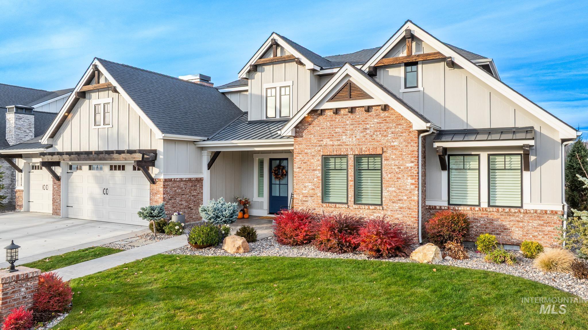 Craftsman house featuring a standing seam roof, a metal roof, board and batten siding, a front yard, and a porch