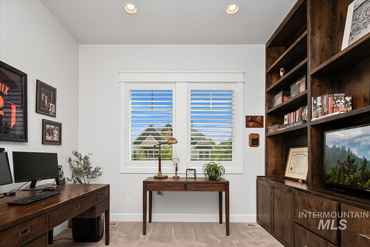 Office area featuring light carpet and recessed lighting