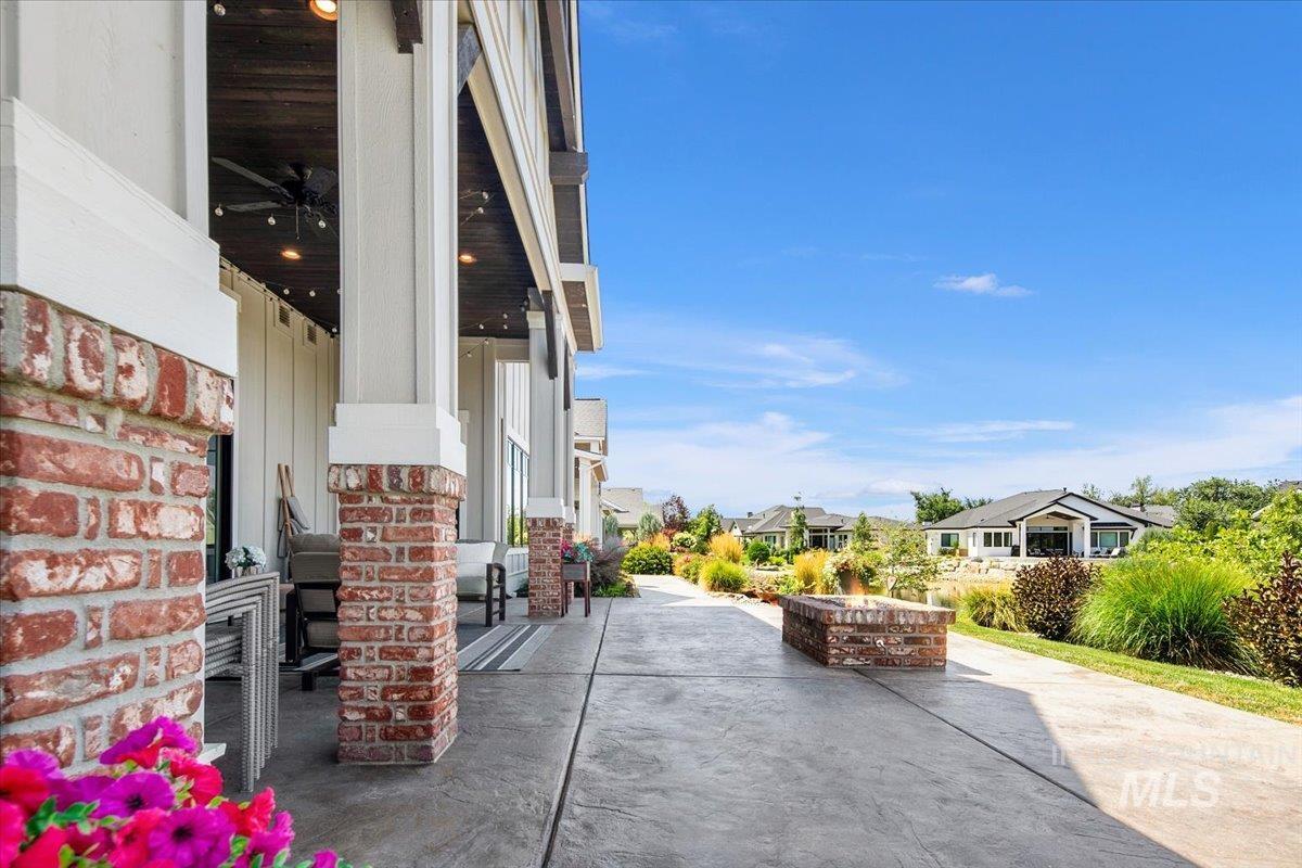 View of patio with a residential view and an outdoor fire pit