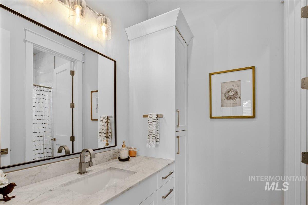 Full bath with vanity and a shower with shower curtain