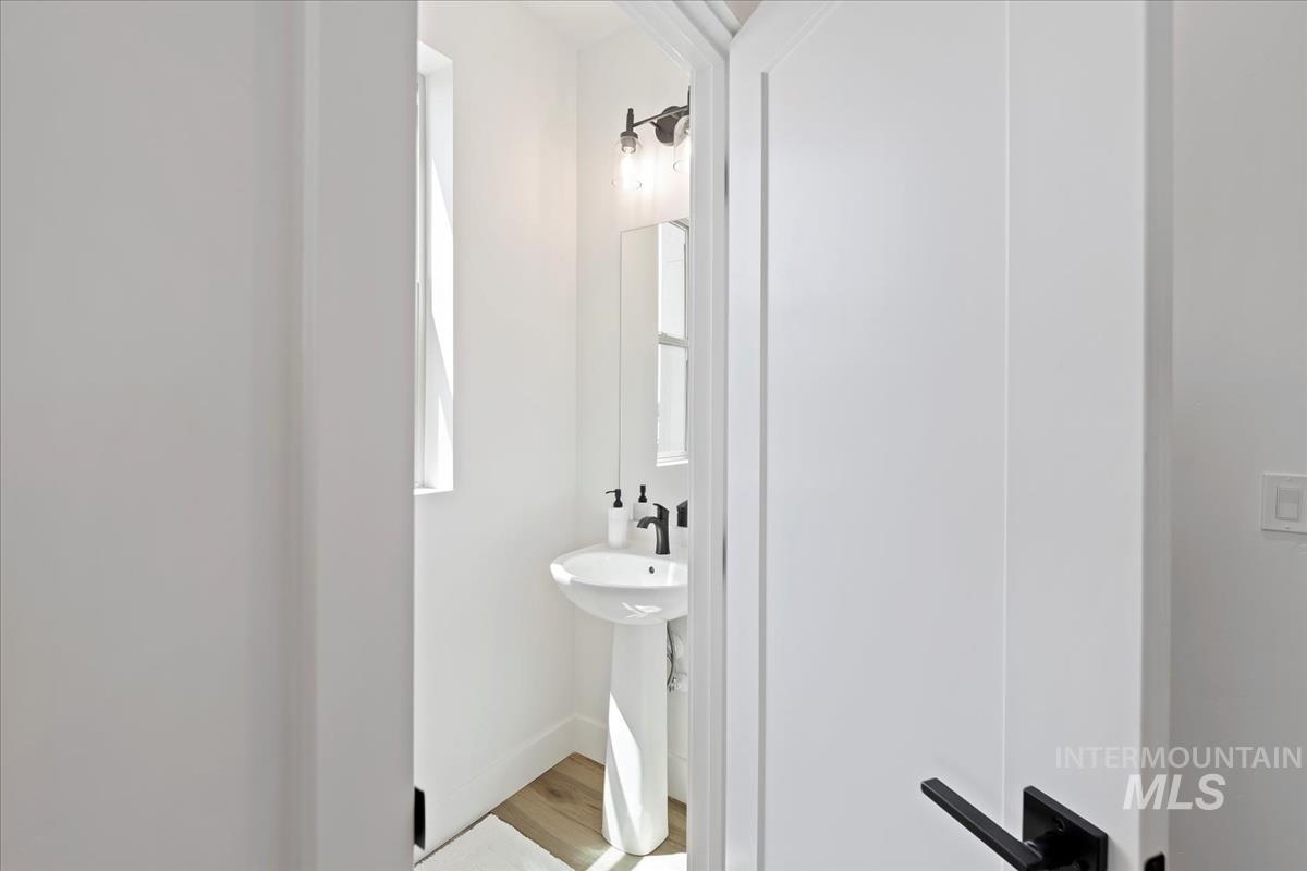 Half bath with light wood-type flooring