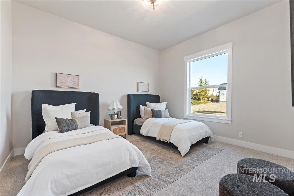Carpeted bedroom featuring baseboards