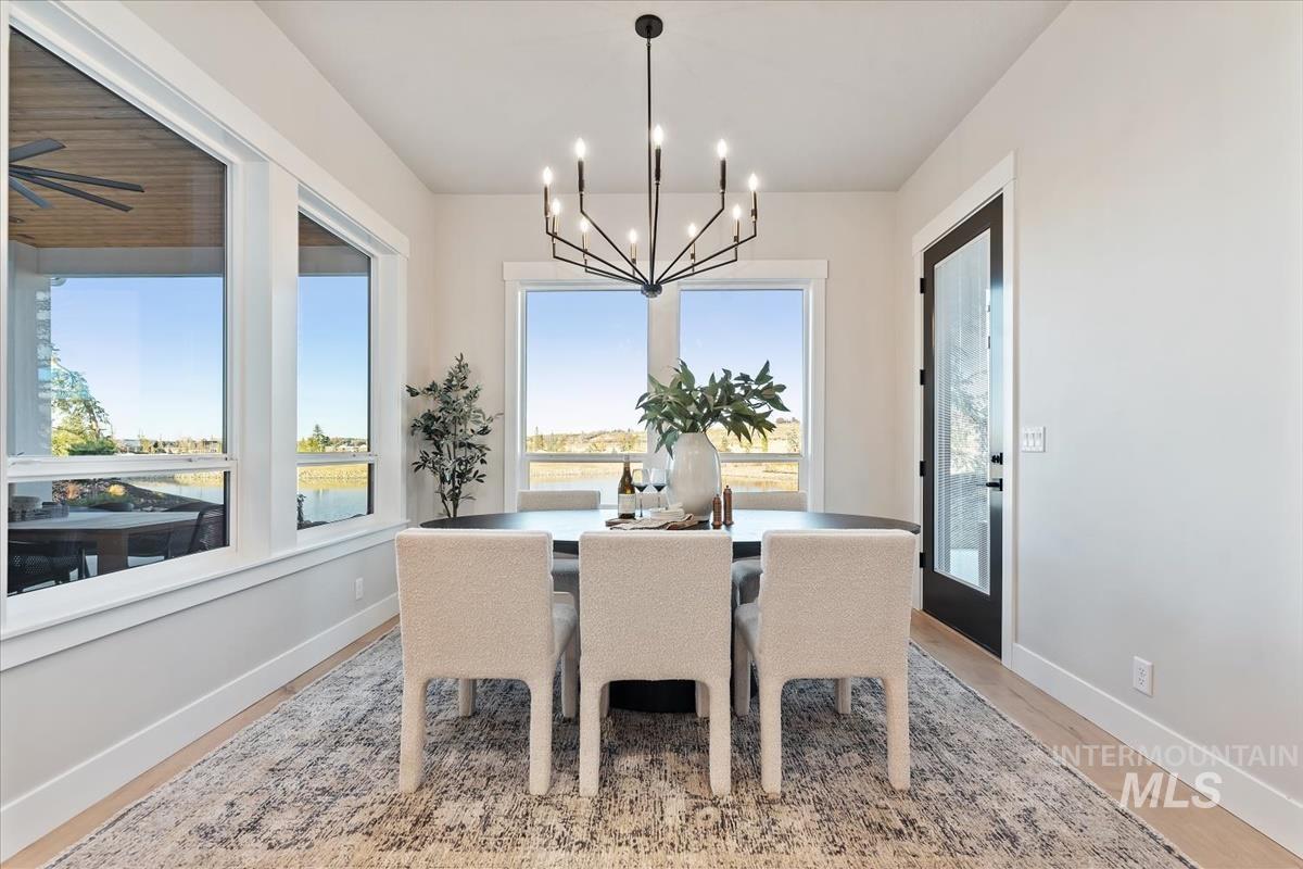 Dining room featuring light wood-style flooring and a chandelier
