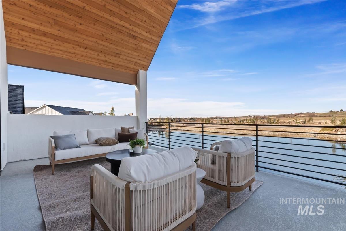 Balcony with outdoor lounge area and a water view