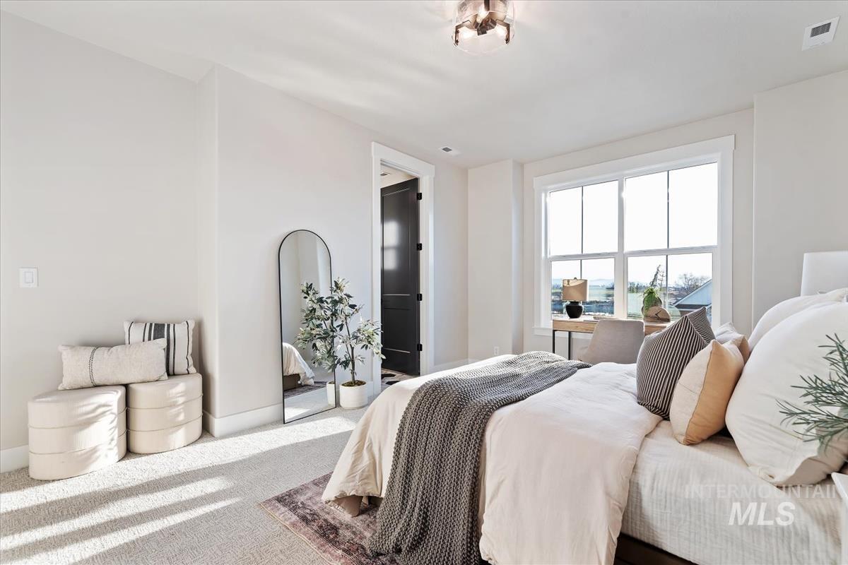 Carpeted bedroom featuring baseboards