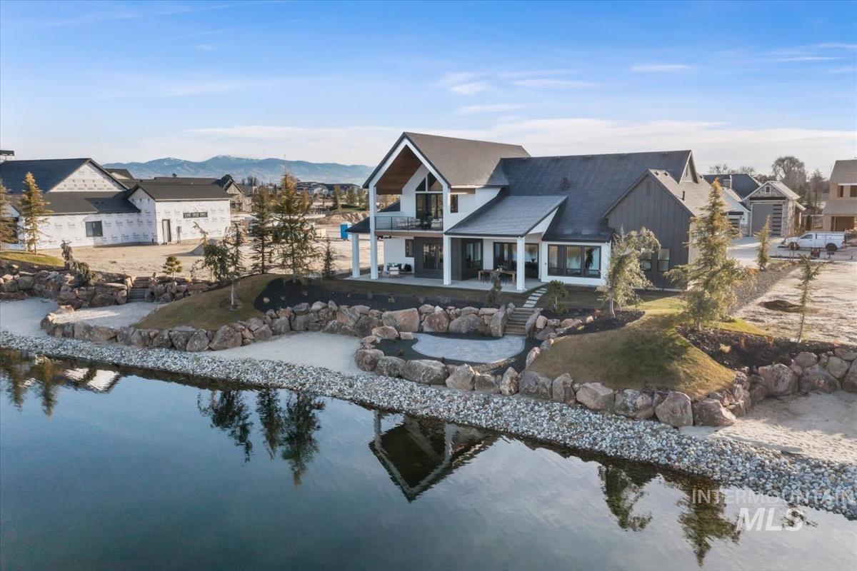 Back of house featuring a patio, a residential view, and a balcony