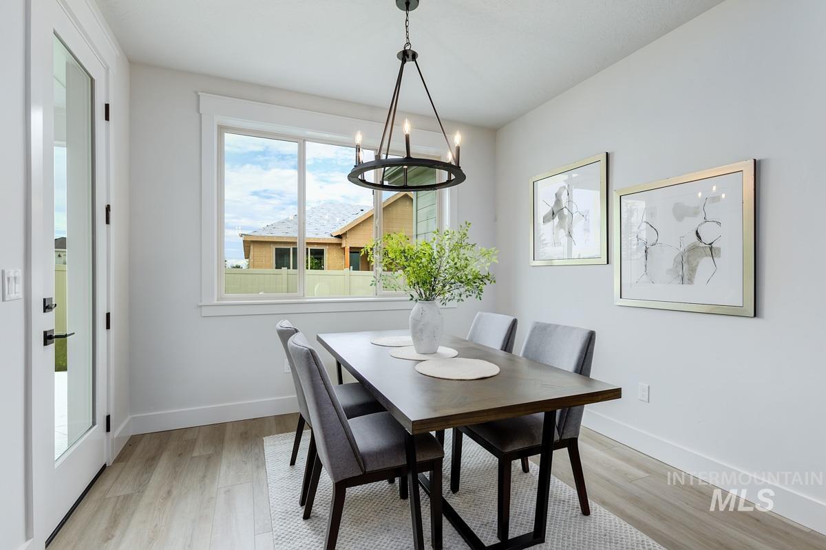 Dining room featuring light wood-style flooring and a chandelier