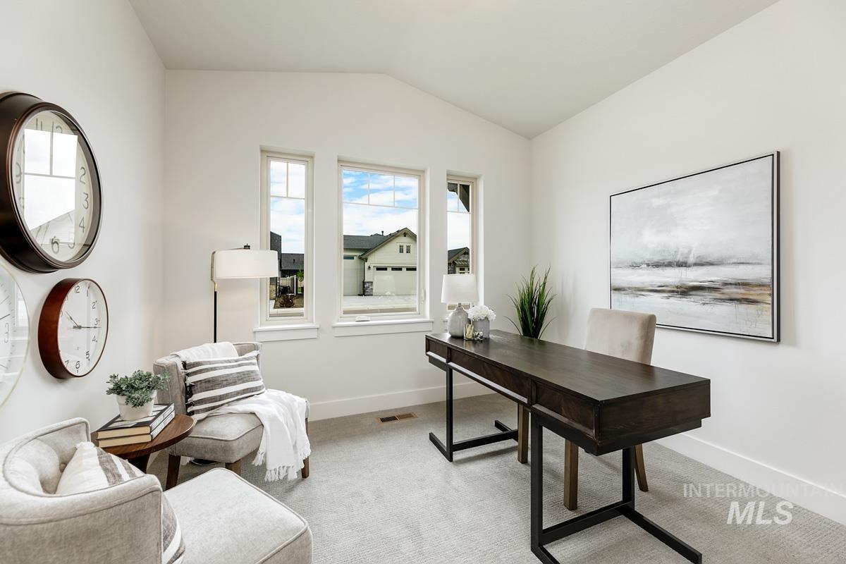 Office featuring light colored carpet and vaulted ceiling