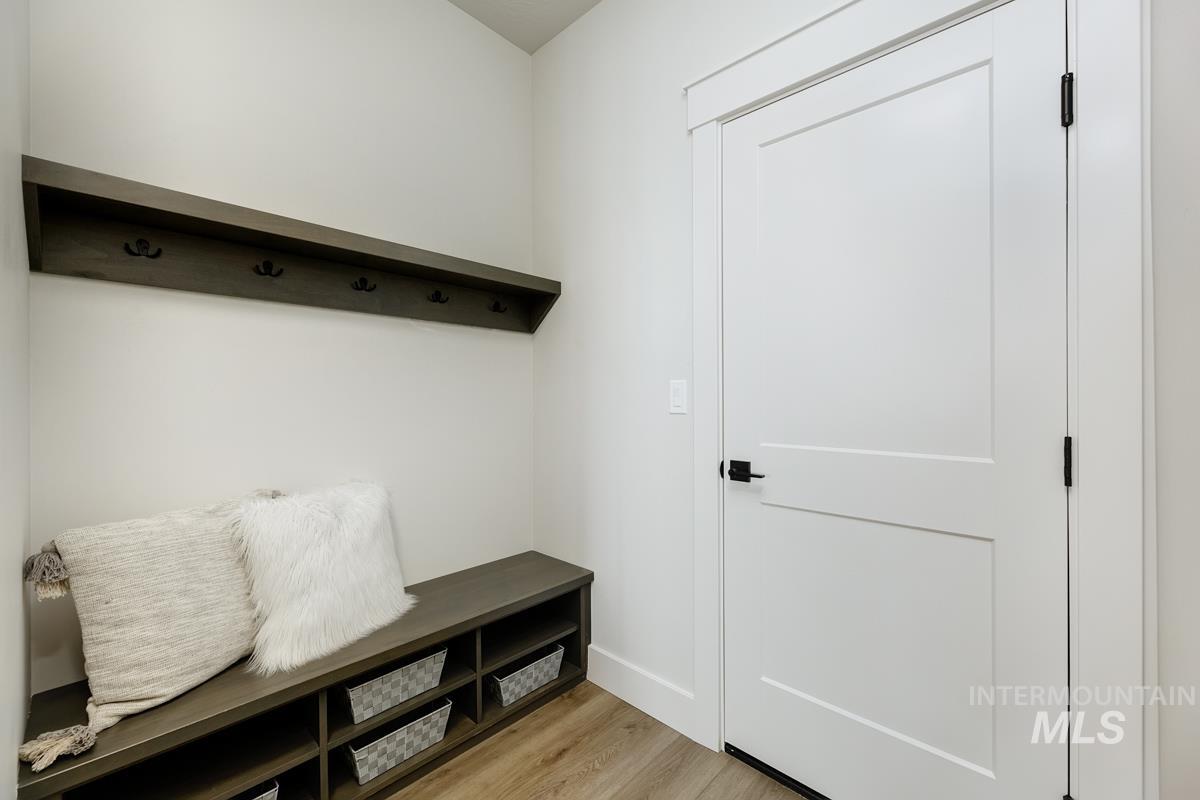 Mudroom featuring light wood-style floors and baseboards