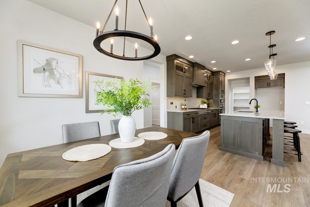 Dining space featuring a chandelier, light wood-style floors, and recessed lighting