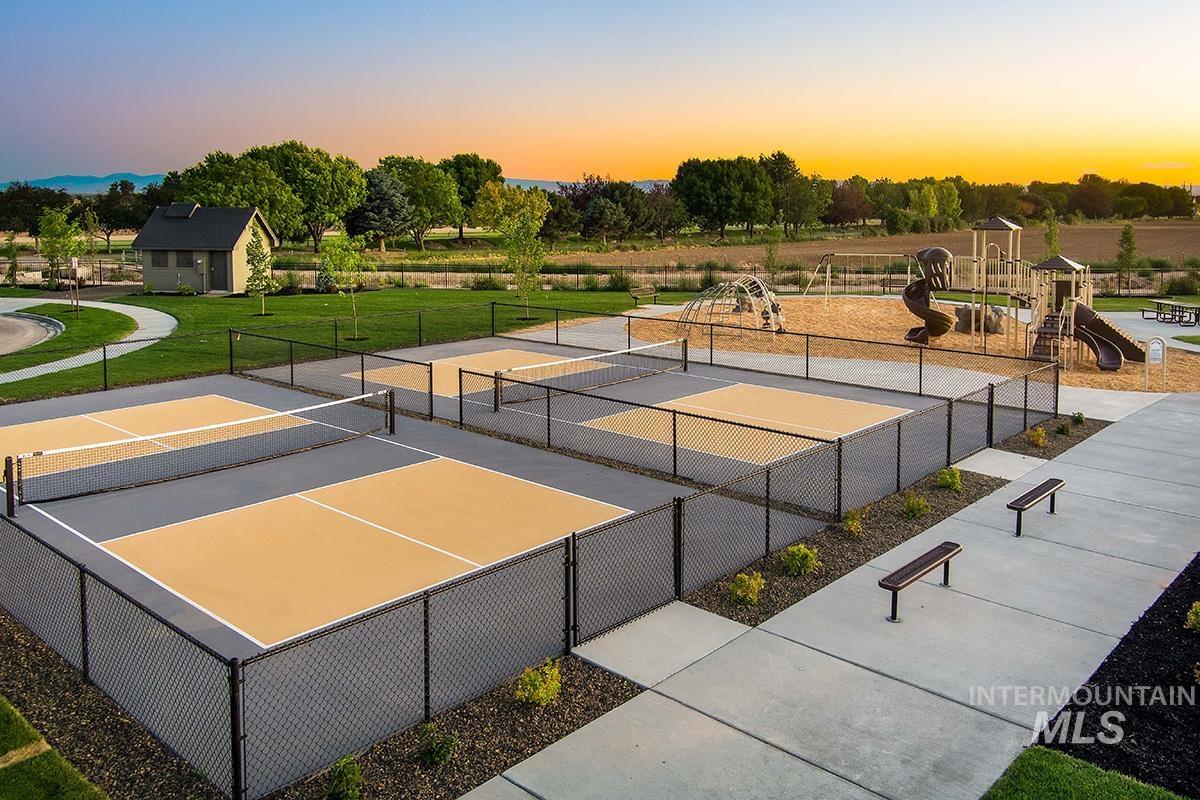 View of tennis court with community basketball court