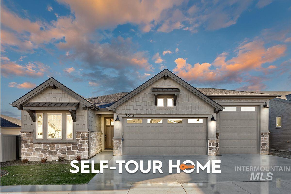 Craftsman-style home featuring stone siding, an attached garage, and concrete driveway