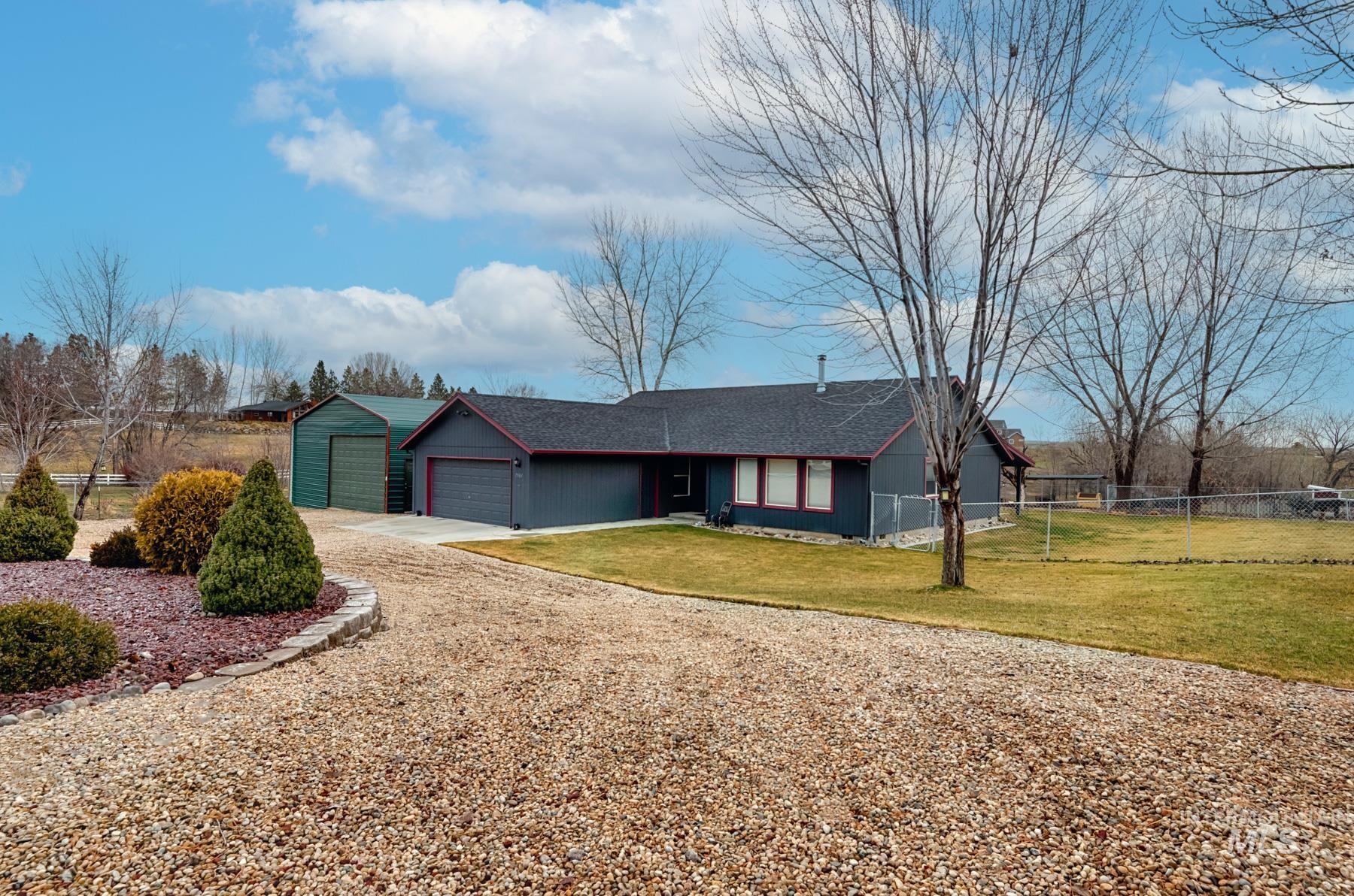 Ranch-style house with roof with shingles, driveway, and a garage