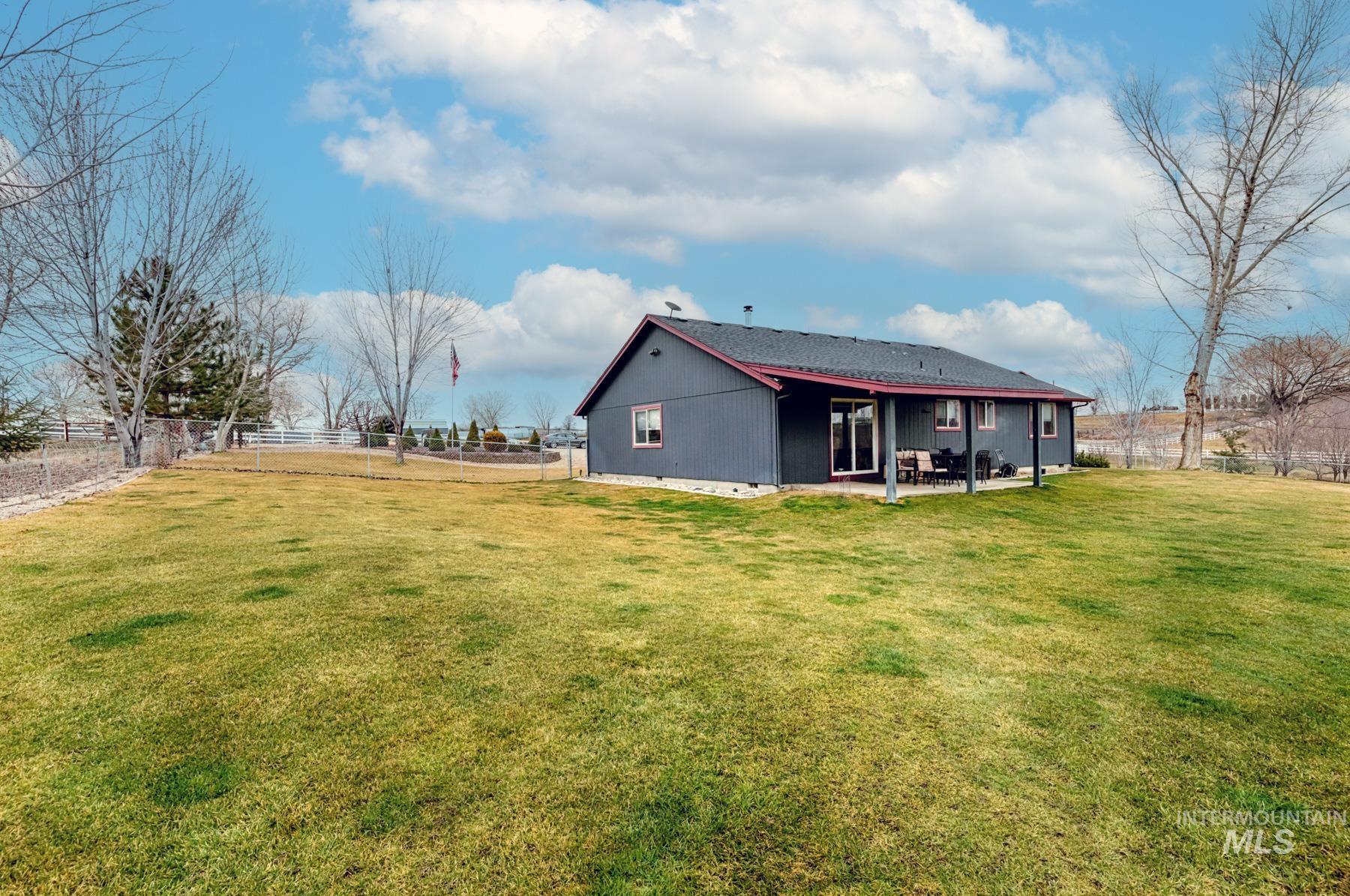 Back of property with a fenced backyard and a patio area