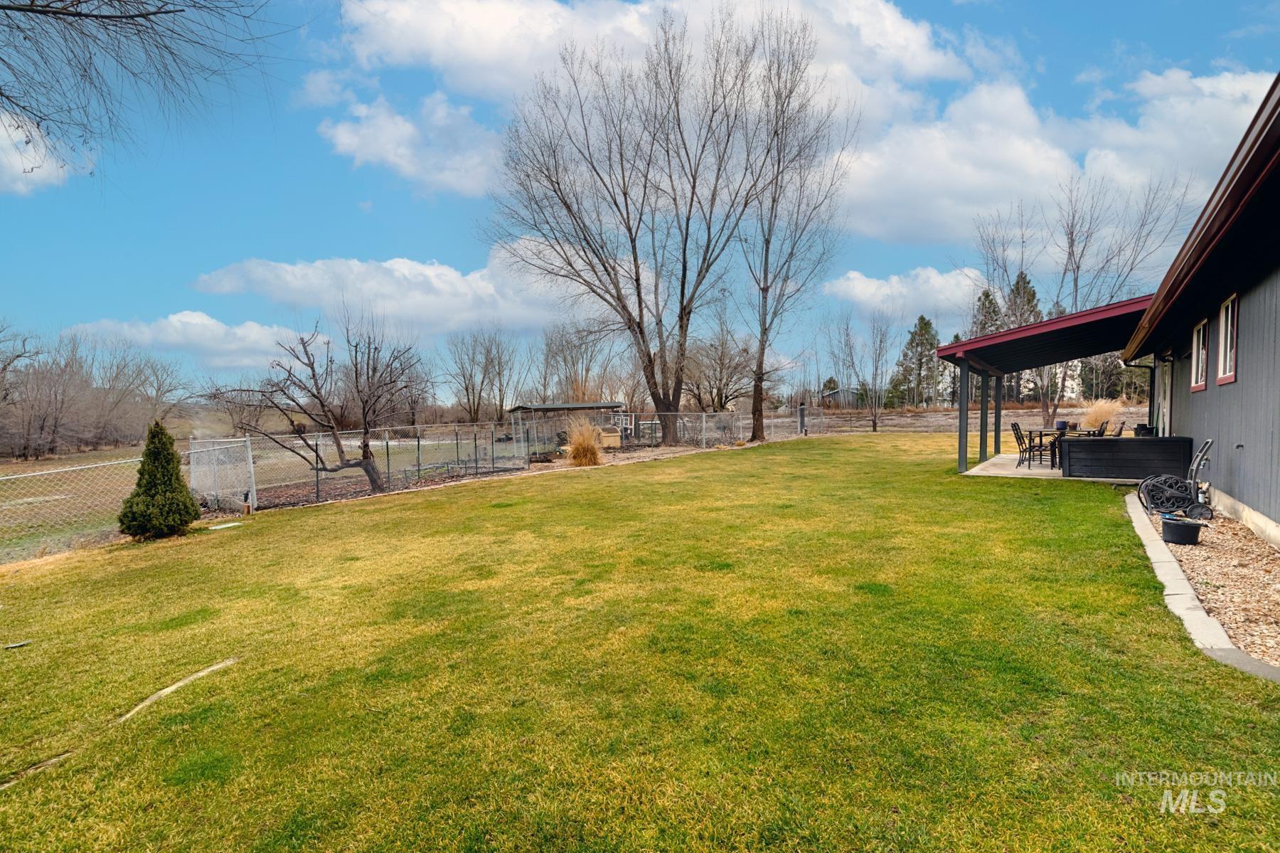 Fenced backyard with a patio area