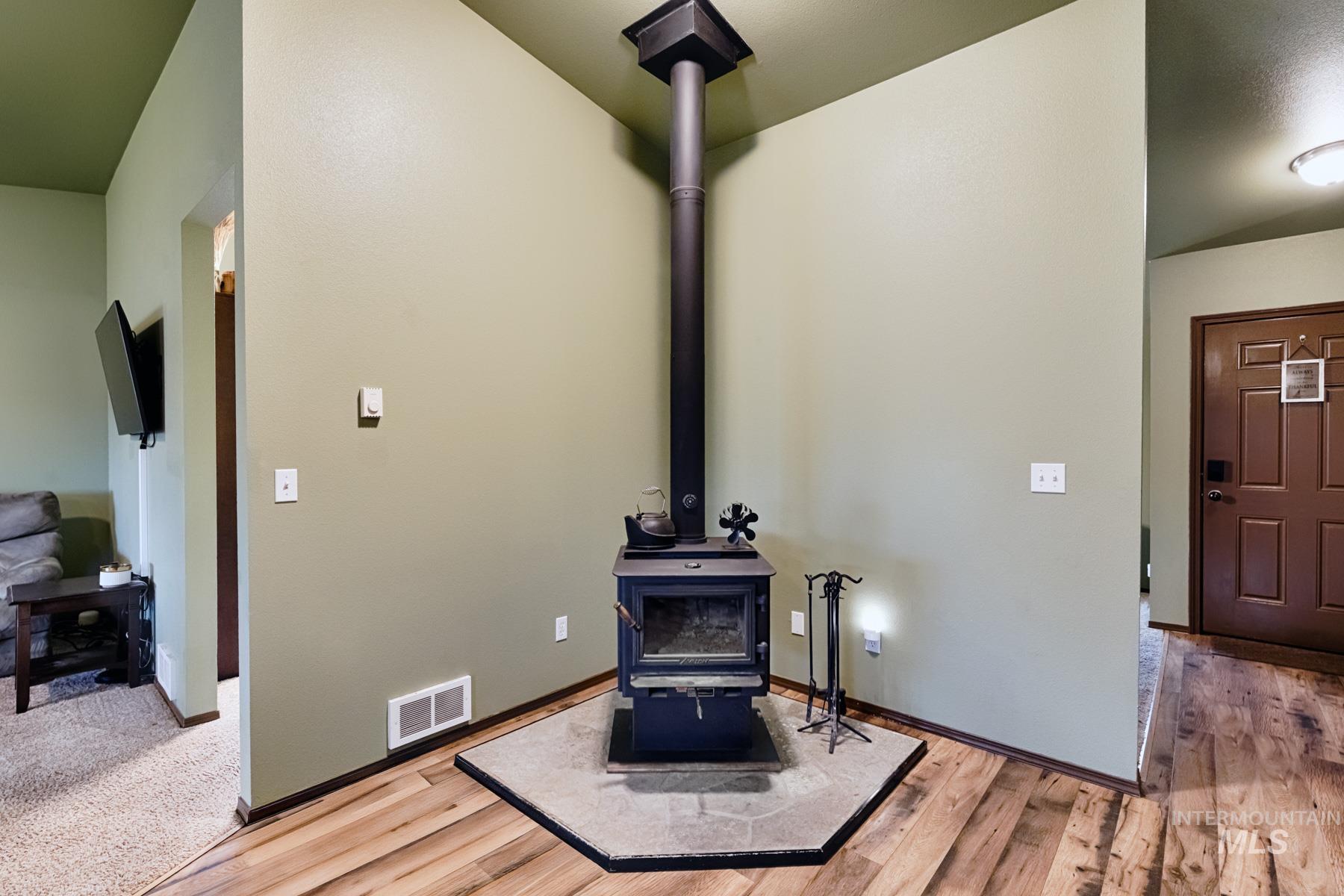 Detailed view of a wood stove and wood finished floors