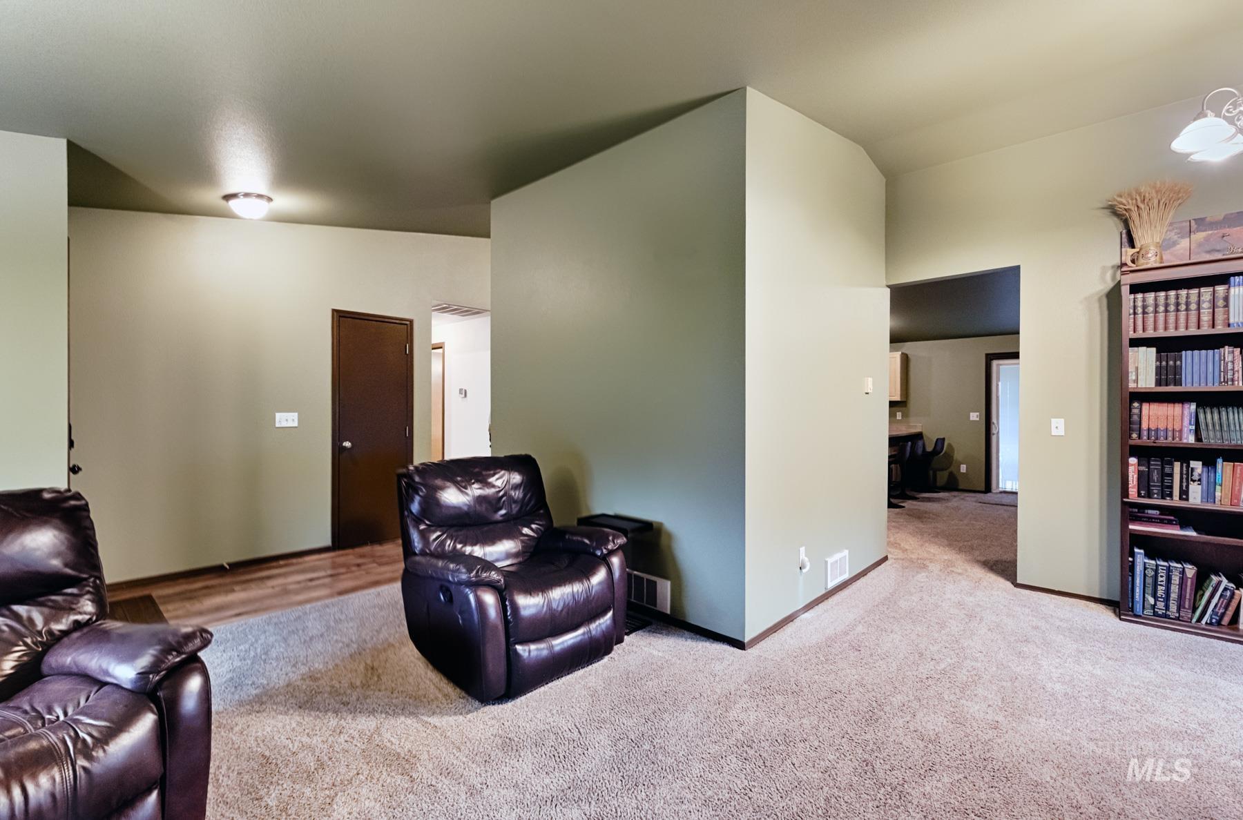 Sitting room featuring baseboards and carpet