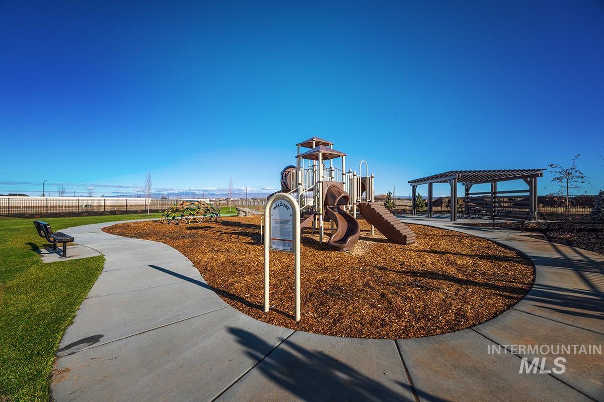 Community playground featuring a multi-level play structure, slide, and climbing dome