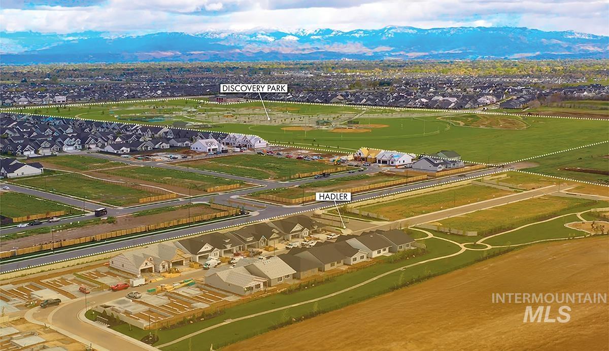 Expansive community development featuring new residential construction, established residential areas, and open parkland