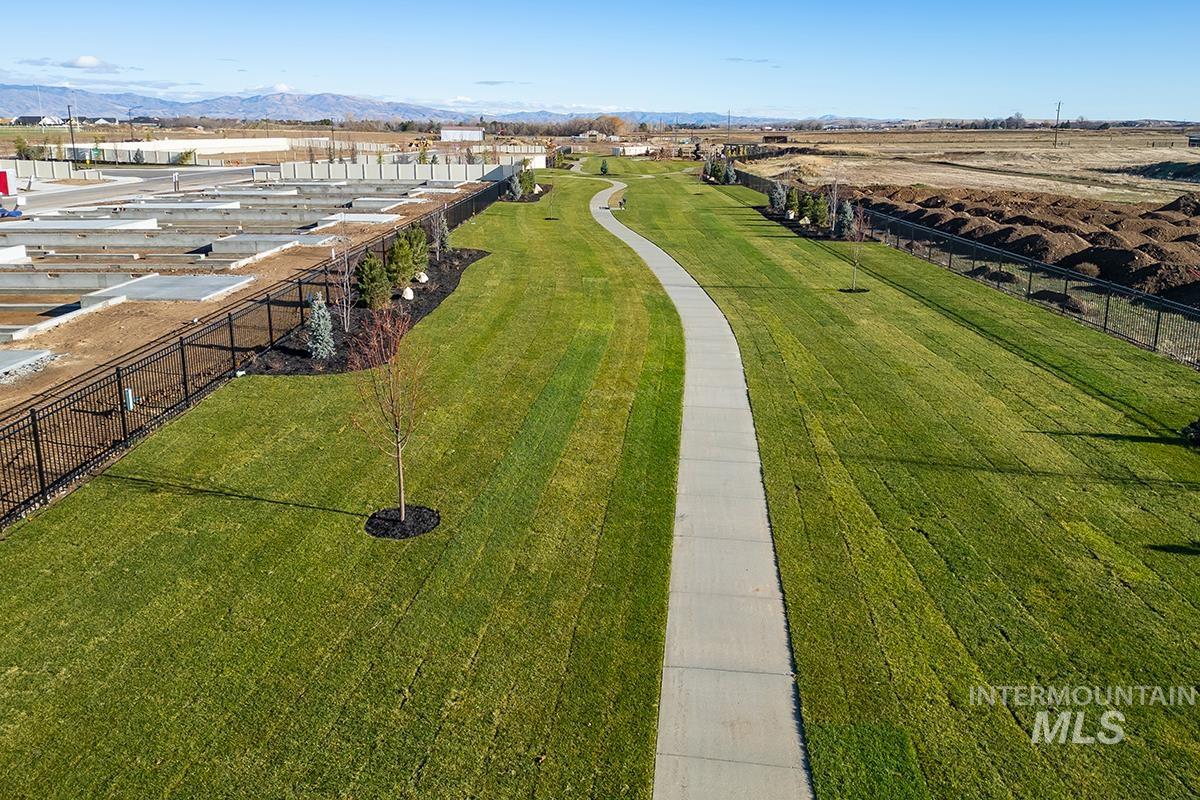 Expansive green space featuring a winding paved pathway